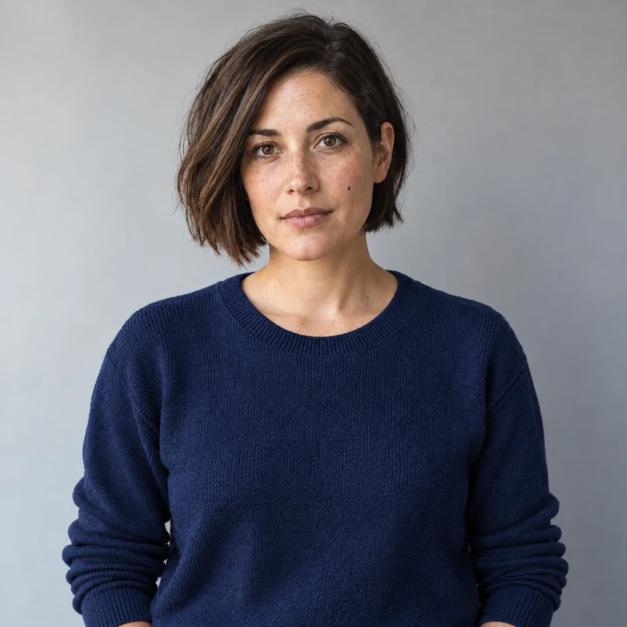 Actual direct clothing edit with a navy sweater and the original gray background